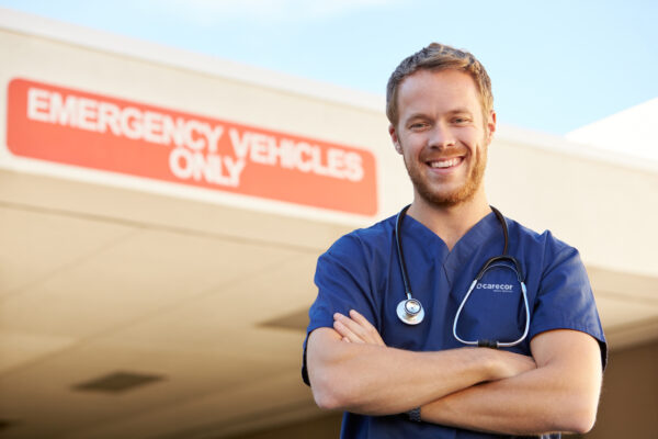 Portrait Of Male Doctor Standing Outside Hospital